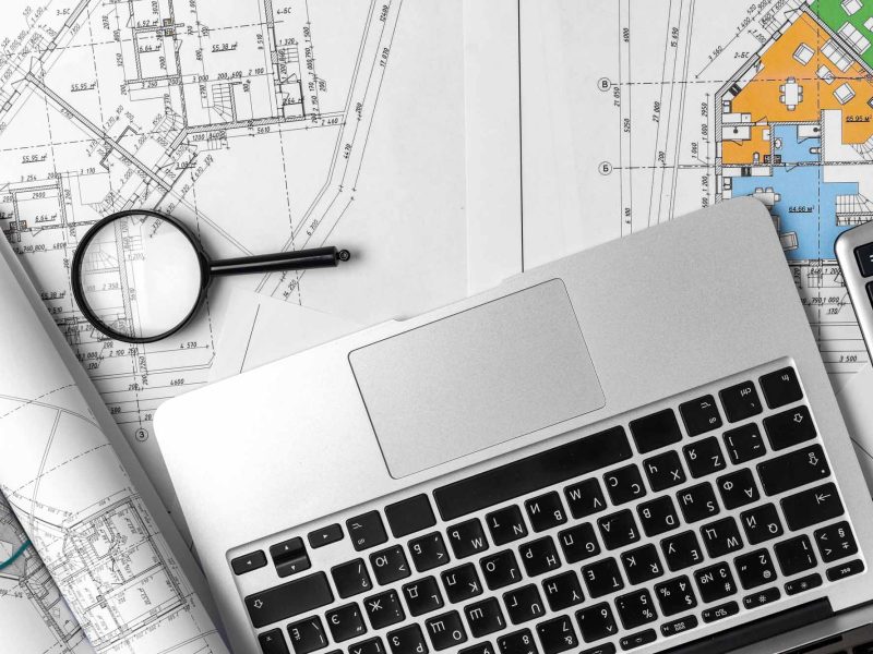 Working table of interior designer with blueprint and laptop, to pview