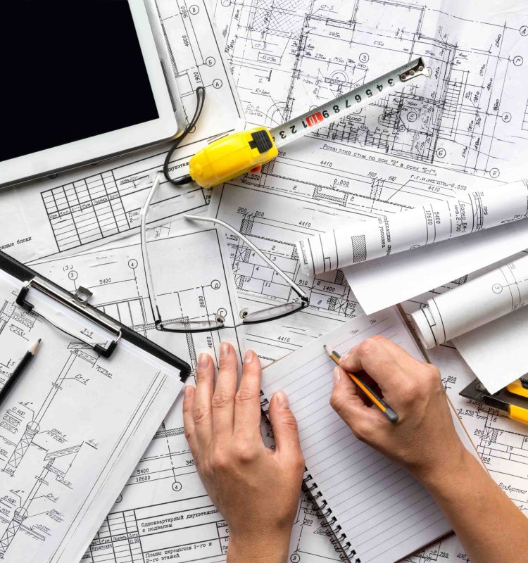 architect design working drawing sketch plans blueprints and making architectural construction model in home